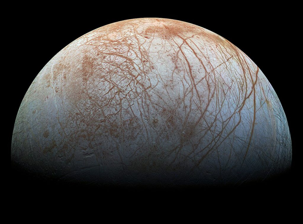 Top half of Europa, one of Jupiter's moons. You see the white surface and red cracks/lines throughout. Image is retouched to showcase the cracks/fissures.