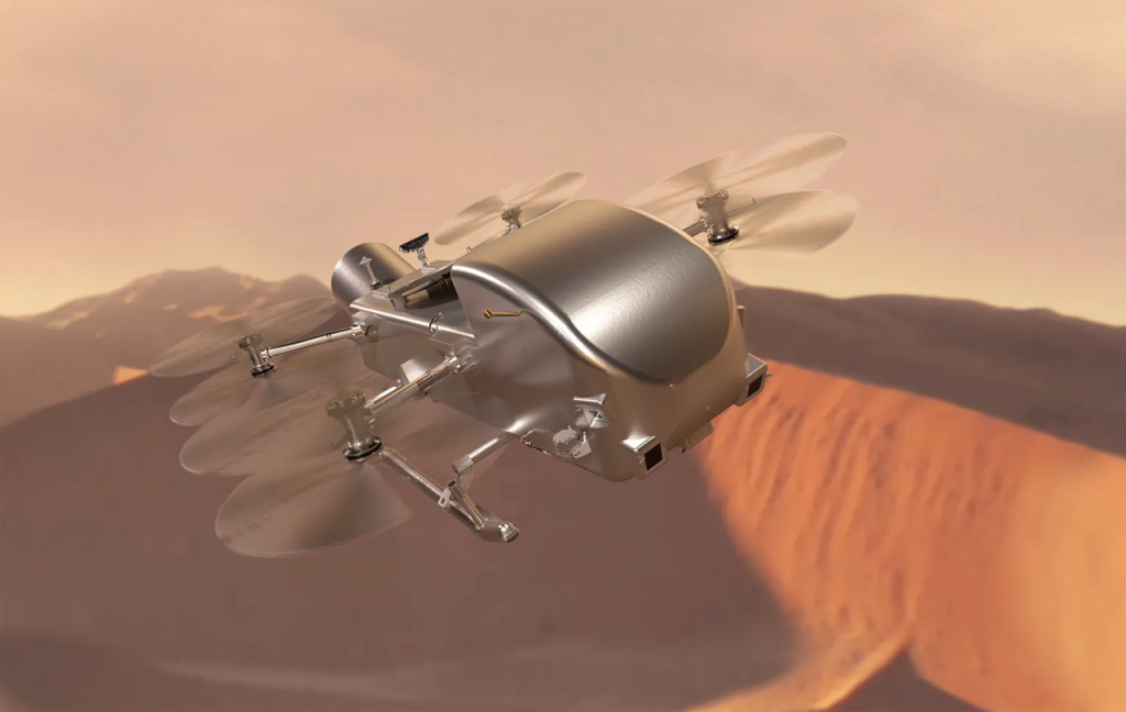 Artist's concept of the Dragonfly rotorcraft drone flying over the sand dunes of Titan's surface in Saturn's hazy atmosphere.